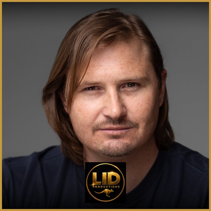 Professional headshot of Brodie Agutter (Bush) on a grey background, with a gold border and the LID Productions logo